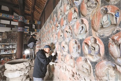 　2023年3月31日，大足石刻小佛灣修復(fù)現(xiàn)場(chǎng)，修復(fù)人員正在對(duì)石窟造像進(jìn)行清理。小佛灣石窟保護(hù)修復(fù)工程于2019年6月啟動(dòng)，目前已完成整個(gè)工程量的六成。  　　黃 舒攝（人民圖片）