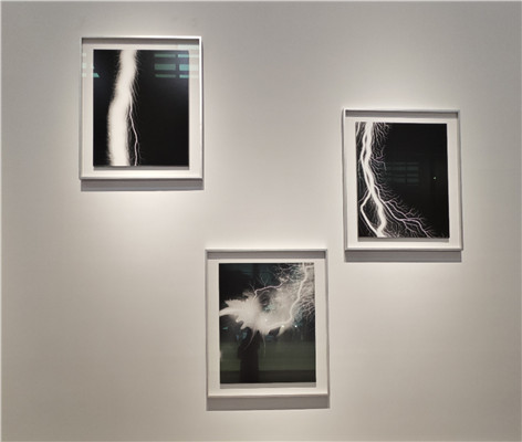 杉本博司“放電場”系列。《筆觸印象·心經(jīng)》之前，藝術(shù)家在暗室中創(chuàng)作“隱形”文本的嘗試早就有跡可循。在2006年開啟的“放電場”系列作品中，杉本博司便已嘗試突破基于鏡頭捕捉的暗室工作方式，用電流導向膠片以獲得圖像。