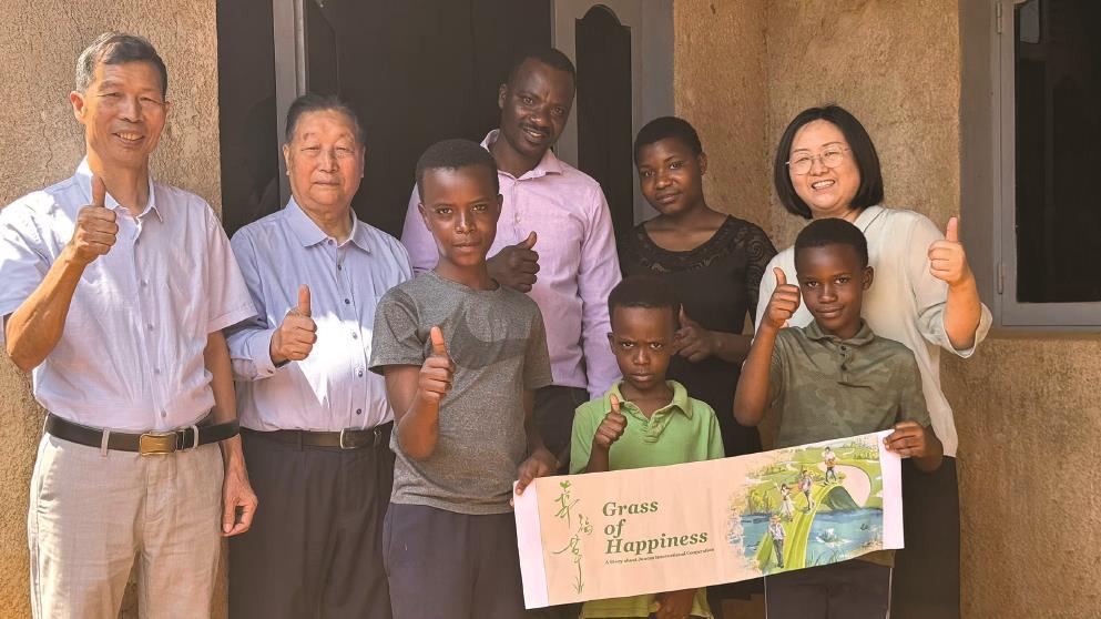 林占熺教授（左二）與盧旺達(dá)當(dāng)?shù)匕傩找黄馂橹袊?guó) 電視劇《幸福草》“打call”。（受訪者供圖）